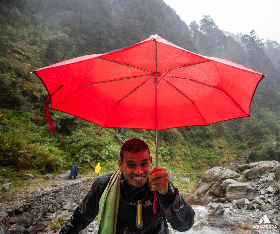 Vikas multi-tasking by offering the umbrella during the rain